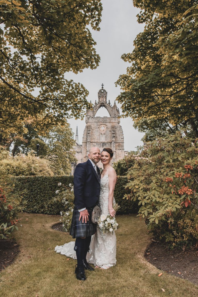 wedding photograph of newly weds outside kings college in Aberdeen