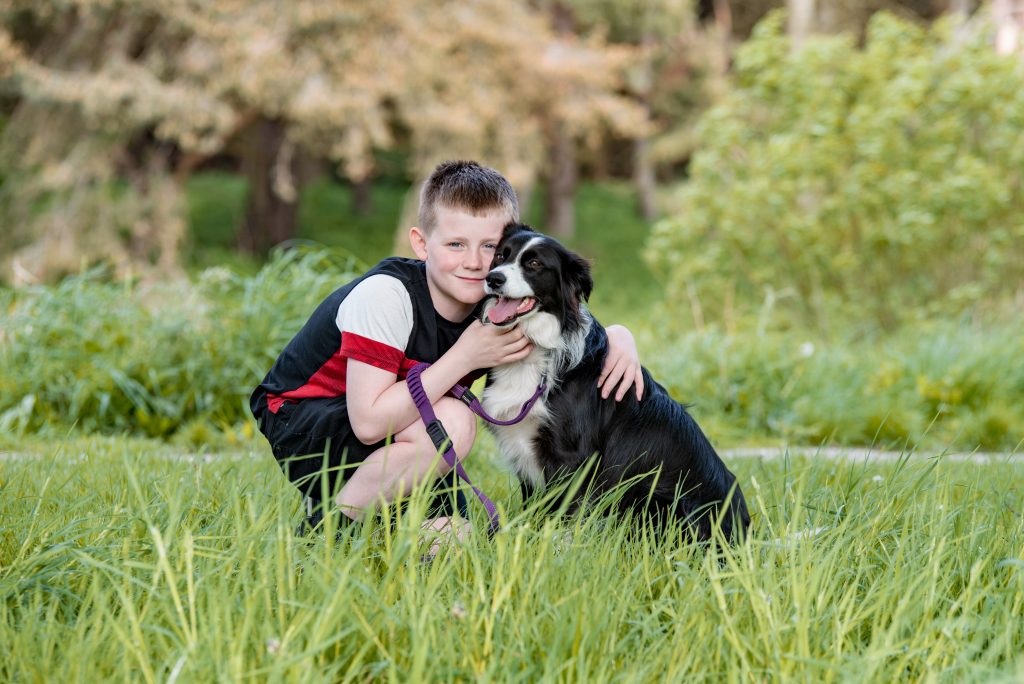 Family Photography in Dyce, Aberdeen - Boy hugging his border collie dog